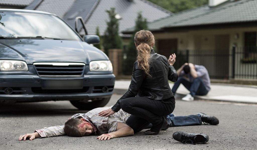 Victim of car accident Bloody victim of car accident lying on the street